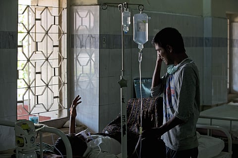 A boy cries standing beside a relative being treated for tuberculosis at a TB hospital in Hyderabad. | AP