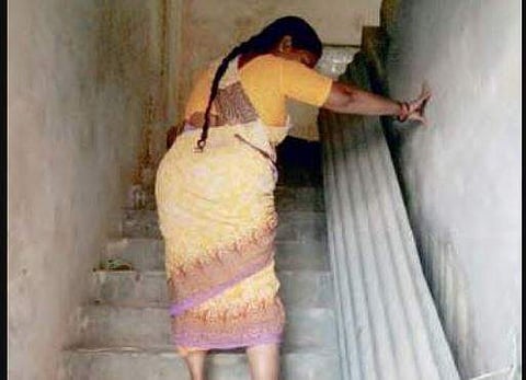A woman suffering from elephantiasis struggles up the stairs to Krishna district’s sole National Filaria Control Unit. Several persons affected by the disease are forced to crawl up the stairs to the unit on the second floor of a chalk factory to get thei