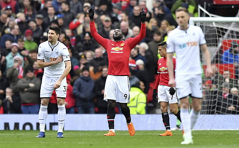 Manchester United's Romelu Lukaku, centre, celebrates scoring his side's first goal of the game against Swansea, during the Premier League soccer match at Old Trafford in Manchester, England, Saturday March 31, 2018. | AP