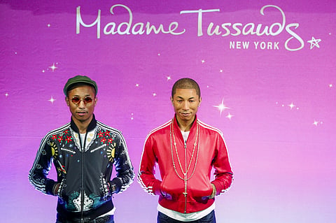 Musician Pharrell Williams (L) poses next to his wax double at Madame Tussauds in New York April 1, 2015. REUTERS