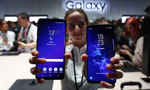 FILE- In this Feb. 25, 2018, file photo, a woman holds the new Galaxy S9 and S9 plus during the Samsung Galaxy Unpacked 2018 event on the eve of the Mobile World Congress wireless show in Barcelona, Spain. | AP