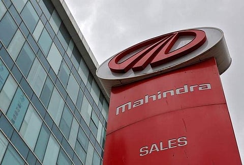The logo of Mahindra and Mahindra is seen at a showroom in Mumbai. (File Photo | Reuters)