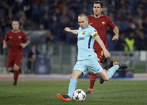 Roma's Kevin Strootman, rear, runs after Barcelona's Andres Iniesta as he takes a shot on goal during the Champions League quarterfinal second leg soccer match between between Roma and FC Barcelona. | AP