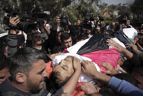 Mourners carry the body of Palestinian journalist  Yasser Murtaja | AP