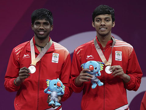 Silver medalists Satwik Rankireddy, left, and Chirag Chandrasekhar Shetty of India, stand on the podium during the medal ceremony for men's doubles badminton at Carrara Sports Hall during the Commonwealth Games on the Gold Coast, Australia, Sunday, April 
