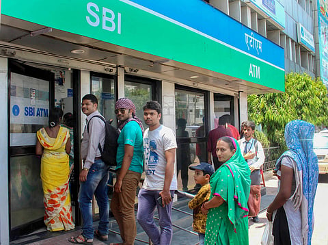 People stand for cash outside at ATM in Bhopal on Tuesday. | PTI