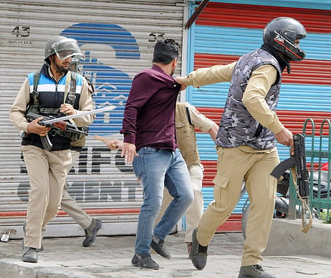 Police arrest a student during clashes following a protest demanding justice for 8-year-old girl who was raped and murdered in Kathua at Sakidafar in Srinagar on Thursday. | PTI