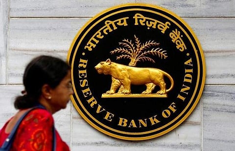 A woman walks past the Reserve Bank of India (RBI) head office in Mumbai. | REUTERS
