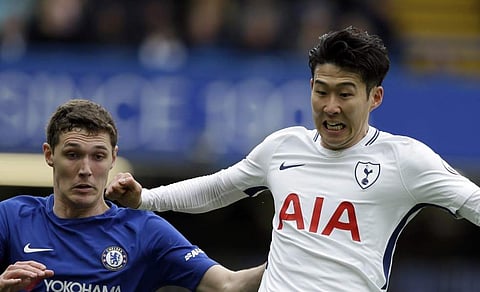 Tottenham's Son Heung-min, right, duels for the ball with Chelsea's Andreas Christensen during the English Premier League soccer match at Stamford Bridge stadium in London. | AP