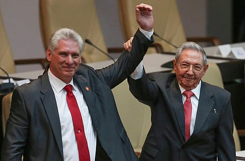 Cuba's outgoing President Raul Castro (right) and new President Miguel Diaz-Canel  (Left) raise their arms in unison. (Photo | AP)