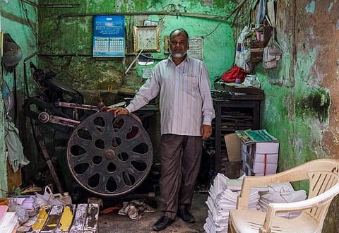 Letterpress printing machine,  which spearheaded the information dissemination from 15th century are in the verge of becoming an archaic object. IN PICTURE: Syed Ahmed, owner and operator of a letterpress printing machine, poses in his shop in the old qua