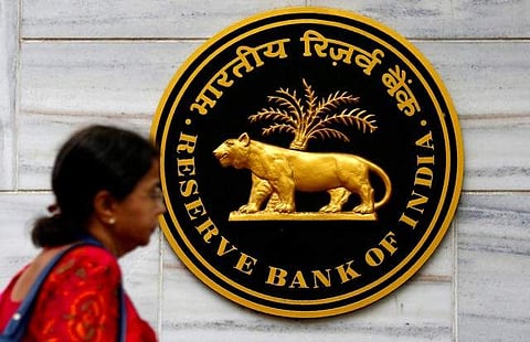 A woman walks past the Reserve Bank of India (RBI) head office in Mumbai. | REUTERS