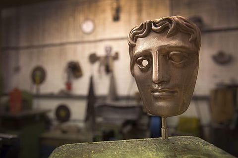 A bronze alloy BAFTA mask stands in a foundry in West Drayton, London, ahead of the award ceremony in February. (Photo | AP)