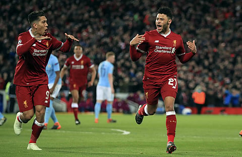 Liverpool's Alex Oxlade-Chamberlain, right, celebrates after scoring his side's second goal of the game during the Champions League quarter final, first leg soccer match between Liverpool and Manchester City at Anfield.  |AP