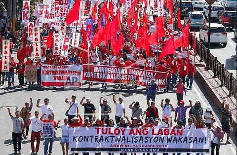 Protesters, mostly workers march towards the Presidential Palace during the global commemoration of Labor Day Tuesday, May 1, 2018 in Manila, Philippines. About 5,000 workers and activists from various groups held a rally Tuesday near the Malacanang Palac