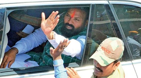 BJP candidate B Sriramulu waves to his supporters after filing nomination in Badami. (File | EPS)
