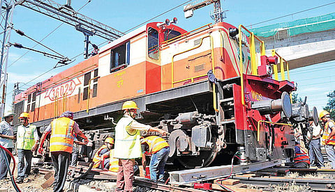 Railway engineers trying to lift the train engine which got derailed at South Railway station on Thursday | A Sanesh