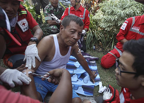 Paramedics tend to a man injured in a church explosion in Surabaya. | AP