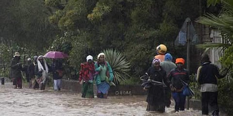 Kenyans pass through a flooded road in Nairobi, Thursday, March 15, 2018. Flooding caused by heavy rain on Thursday posed difficulties for those traveling to work. (Photo: AP)
