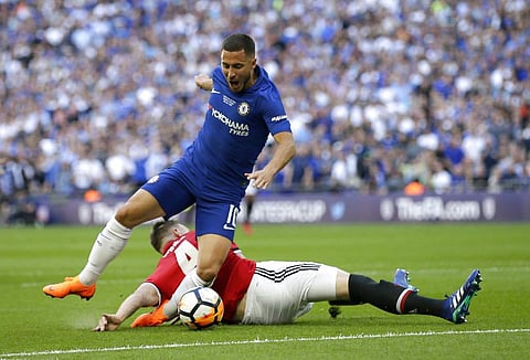Manchester United's Phil Jones, on the ground, fouls Chelsea's Eden Hazard in the box to give away a penalty shot during the English FA Cup final soccer match between Chelsea and Manchester United at Wembley stadium in London. | AP