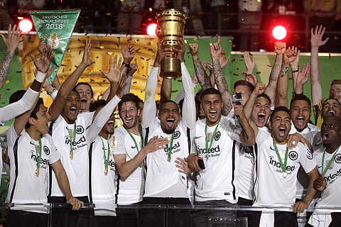 Eintracht Frankfurt's Kevin-Prince Boateng lifts the trophy after winning the German soccer cup final match against FC Bayern Munich in Berlin. | AP