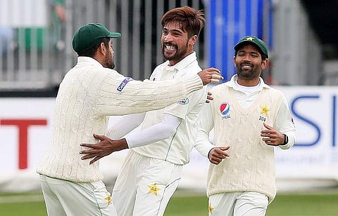 Pakistan's Mohammad Amir (C) celbrates taking the wicket of Ireland's Niall O'Brien for 18 runs during play on day four of Ireland's inaugural test match against Pakistan at Malahide cricket club, in Dublin on May 14, 2018. | AFP