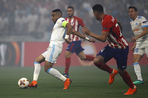 Marseille's Dimitri Payet, left, and Atletico's José María Gimenez, second right, vie for the ball during the Europa League Final soccer match between Marseille and Atletico Madrid at the Stade de Lyon in Decines, outside Lyon, France, Wednesday, May 16, 