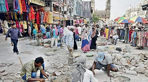 GHMC workers carry out road repair works near Charminar on  Monday| vinay madapu