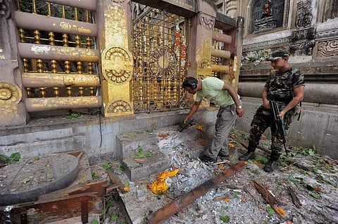Security personnel inspecting the blast site at Bodh Gaya in July 2013. (File PTI photo)