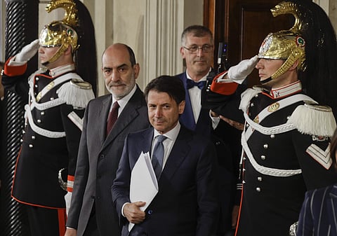 Giuseppe Conte arrives to address the media after meeting Italian President Sergio Mattarella, at the Quirinale presidential palace in Rome on Wednesday. (AP)