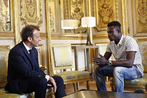 Mamoudou Gassama living illegally in France is being honored by Macron for scaling an apartment building over the weekend to save a 4-year-old child dangling from a fifth-floor balcony. | AP