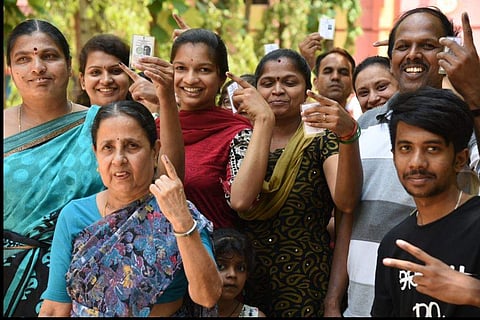 People showing their voter IDs and inked fingers after voting at a polling booth. Image used for representational purpose only. (Express Photo| Nagaraja Gadekal)