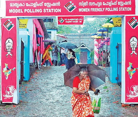 A woman comes out of a model polling station after casting vote | Express