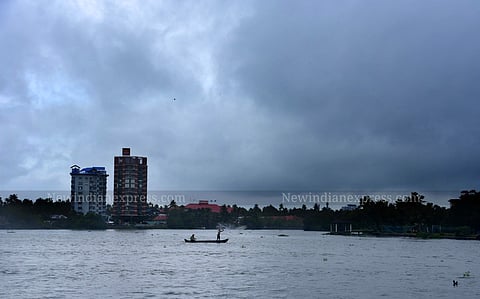 Two fishermen trying their luck to get hold of fishes just before the heavy downpour in Kochi, Kerala. 