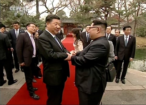 File image of North Korean leader Kim Jong Un, right, and Chinese counterpart Xi Jinping, left, shake hands at Diaoyutai State Guesthouse in Beijing. (File | AP)