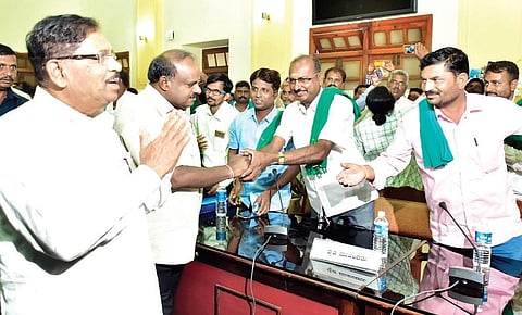 Chief Minister H D Kumaraswamy and Deputy Chief Minister G Parameshwara interact with farmer leaders at Vidhna Soudha in Bengaluru on Wednesday | Express
