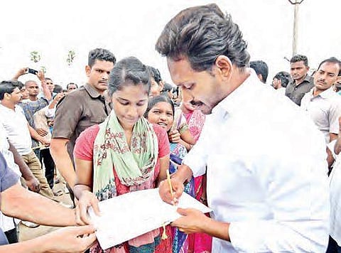 YSR Congress (YSRC) president YS Jaganmohan Reddy signing an autograph for a student at Machilipatnam in Krishna district on Thursday | Express