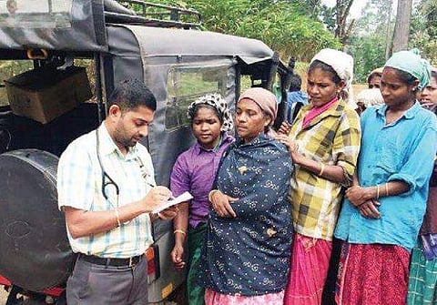 Dr Adarsh consulting the tribes beside a hired jeep at tribal settlements inside Mankulam forest division | Express