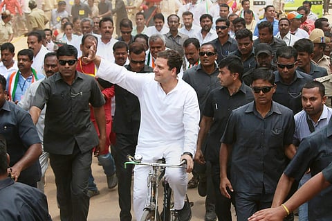 Congress President Rahul Gandhi rides a bicycle to protest against the fuel price hike at Malur in Kolar district on Monday. | PTI