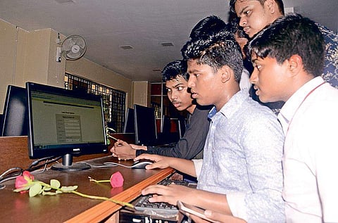 Students checking their results on internet at a school in Bhubaneswar on Monday