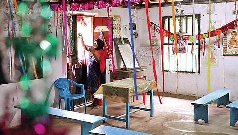 A teacher decorating a classroom to welcome new students at Union LP School, SRM Road in Kochi on Thursday | Melton Antony