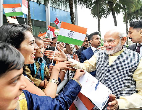 PM Narendra Modi being greeted by members of the Indian community on his arrival in Singapore on Thursday | PTI