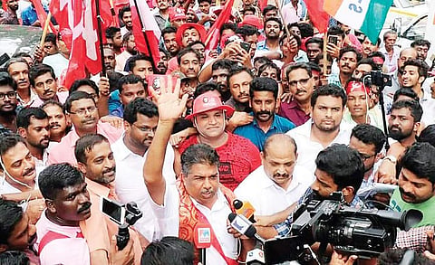 Left Democratic Front’s Saji Cheriyan acknowledges supporters’ cheers during his victory parade | express