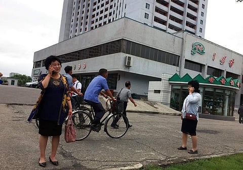 Residents go about their business near one of the city’s biggest department stores and shopping areas in Pyongyang, North Korea Sunday, June 10, 2018. Despite the focus of world attention on the upcoming summit in Singapore between US President Donald Tru