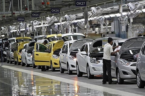 Workers assemble cars at a car manufacturing unit. (File photo | Reuters)