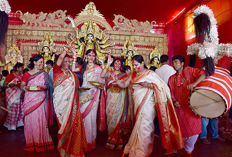 Devotees celebrate Sindur Khela at Arambagh Puja Pandal on the last day of Durga puja in New Delhi on Saturday. (Photo | PTI)