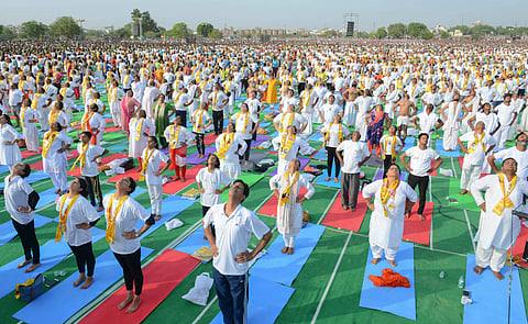 Yoga enthusiasts perform during an event by Guru Ramdev Baba and Rajasthan Chief Minister Vasundhara Raje to set the Guinness World Record for 'The Largest Yoga Lesson' during the International Day of Yoga in Kota on Thursday June 21 2018. | PTI