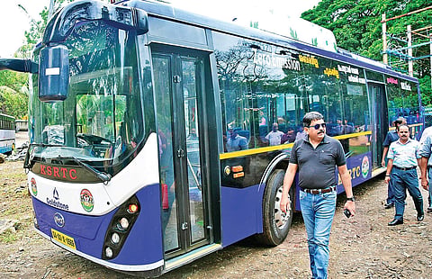 KSRTC chairman and managing director Tomin J Thachankary standing beside the electric bus. File | EPS