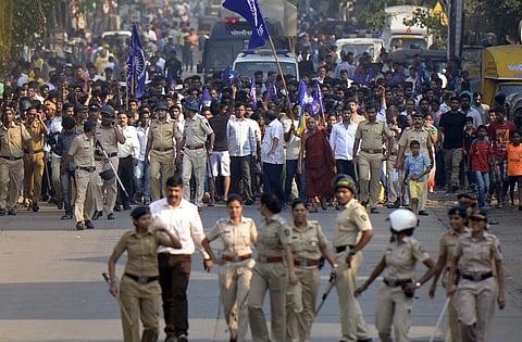 In this file photo, Mumbai Policemen accompany the Dalits protestors as they stage a protest against the violence in Bhima Koregaon area of Pune in Mumbai. (Photo | PTI)