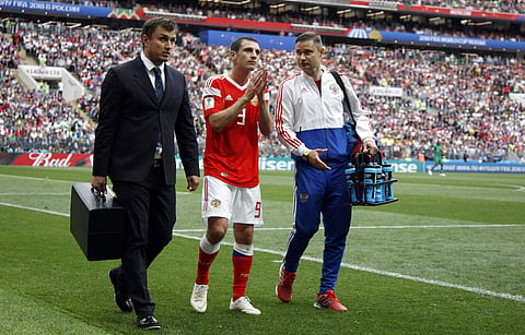Russia's Alan Dzagoev leaves the pitch injured during the group A match between Russia and Saudi Arabia which opens the 2018 soccer World Cup at the Luzhniki stadium in Moscow. | AP